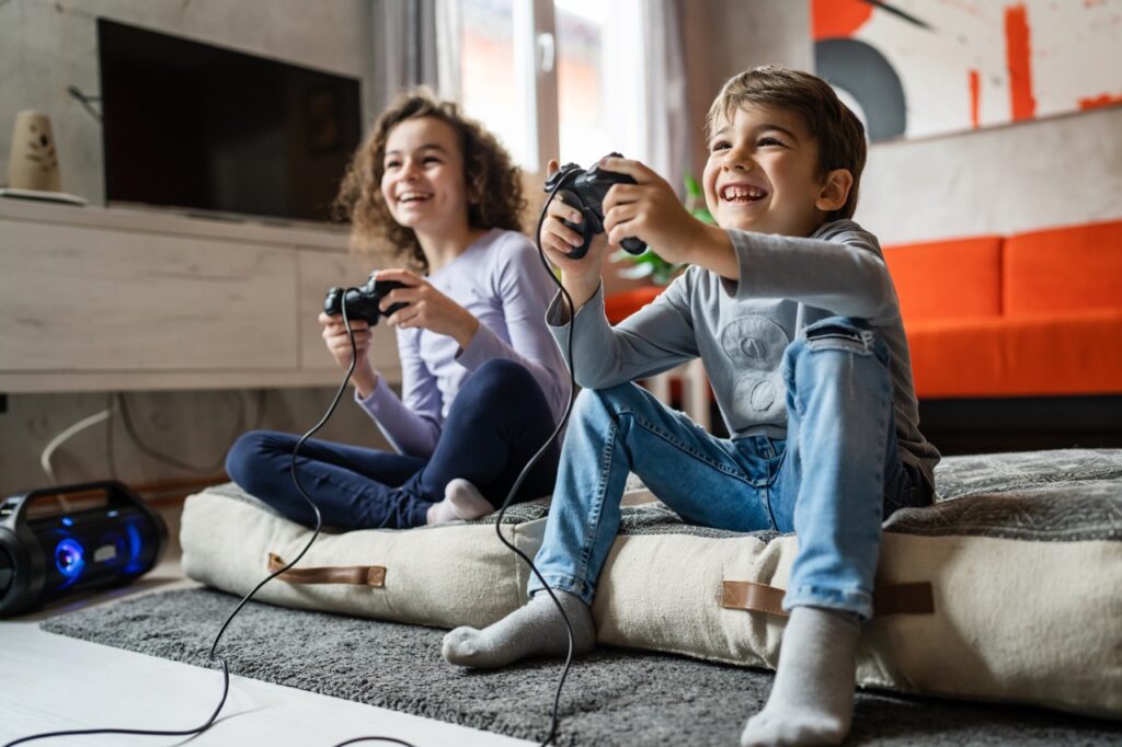 Brother and sister playing video games together