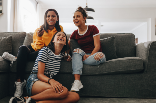 three girls sitting on a couch
