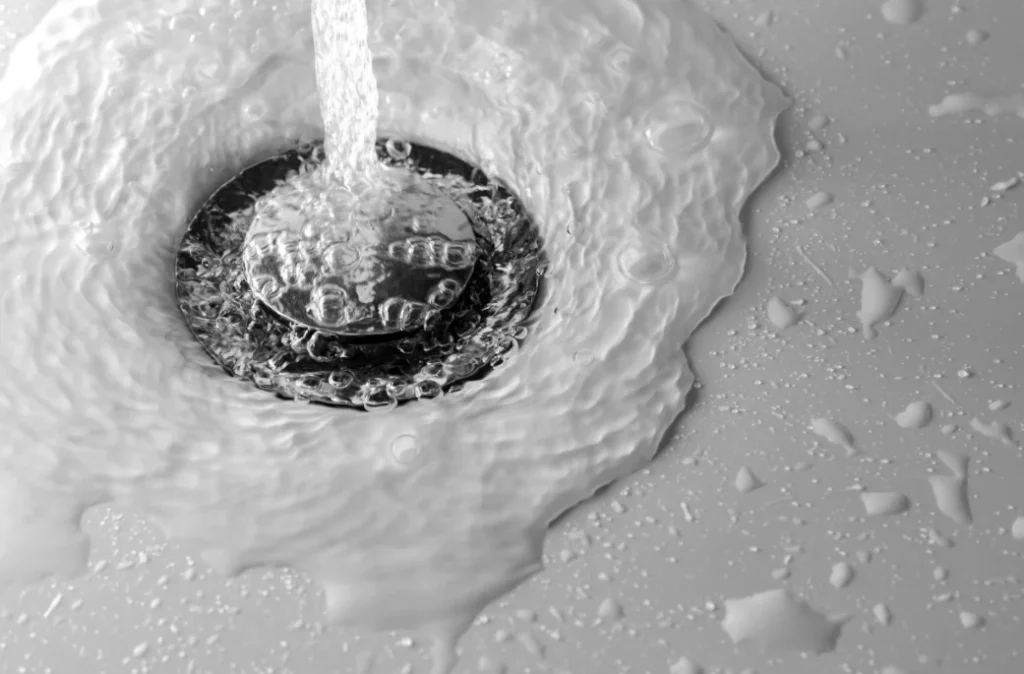 Water running freely out of a drain after professional drain cleaning